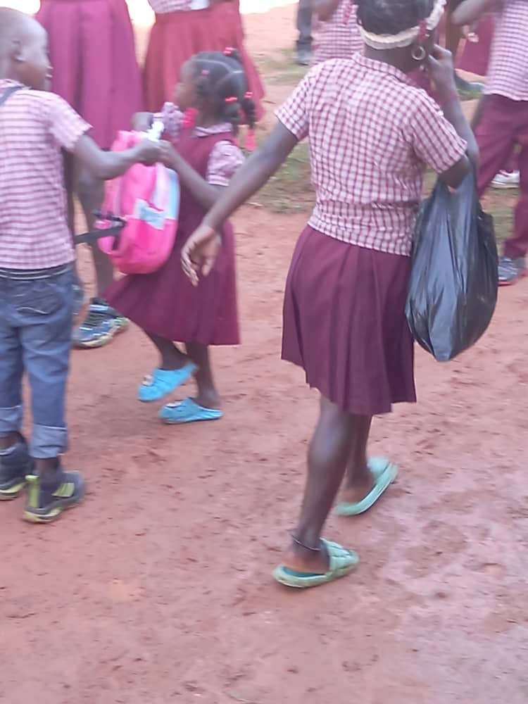 Boys in uniforms with worn and mismatched shoes