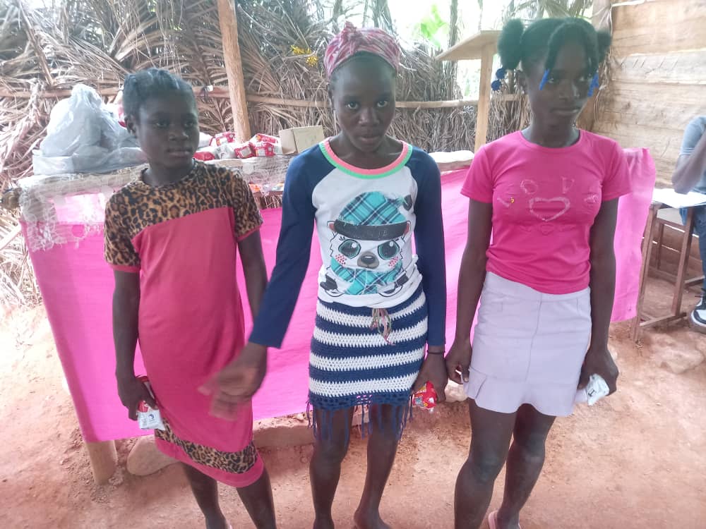 Children sitting packed together waiting quietly