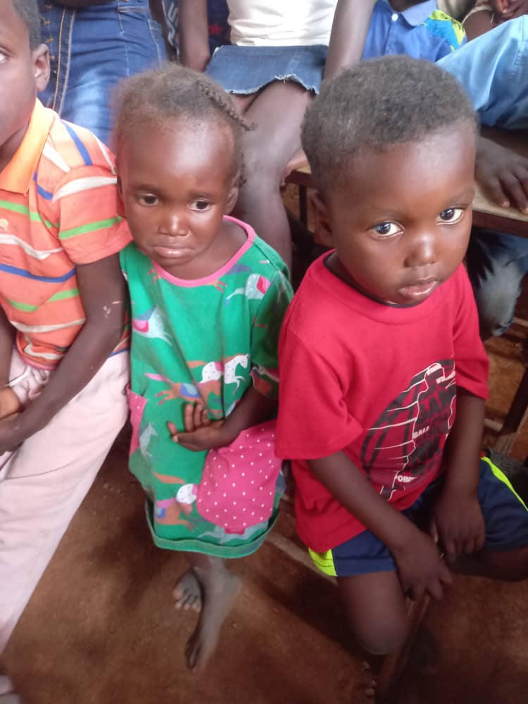 A small girl in uniform glancing aside