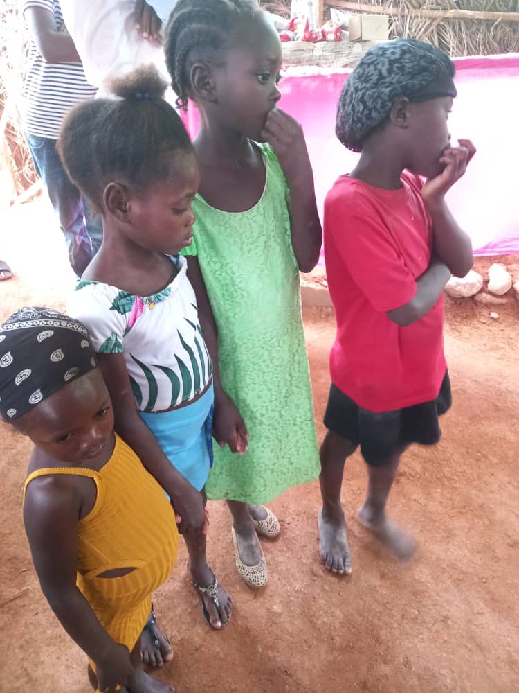 Young girls sitting together holding snack packages